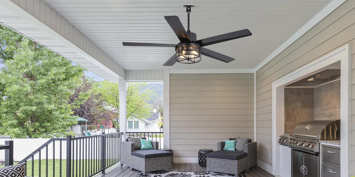 Black ceiling fan with light on a covered outdoor patio